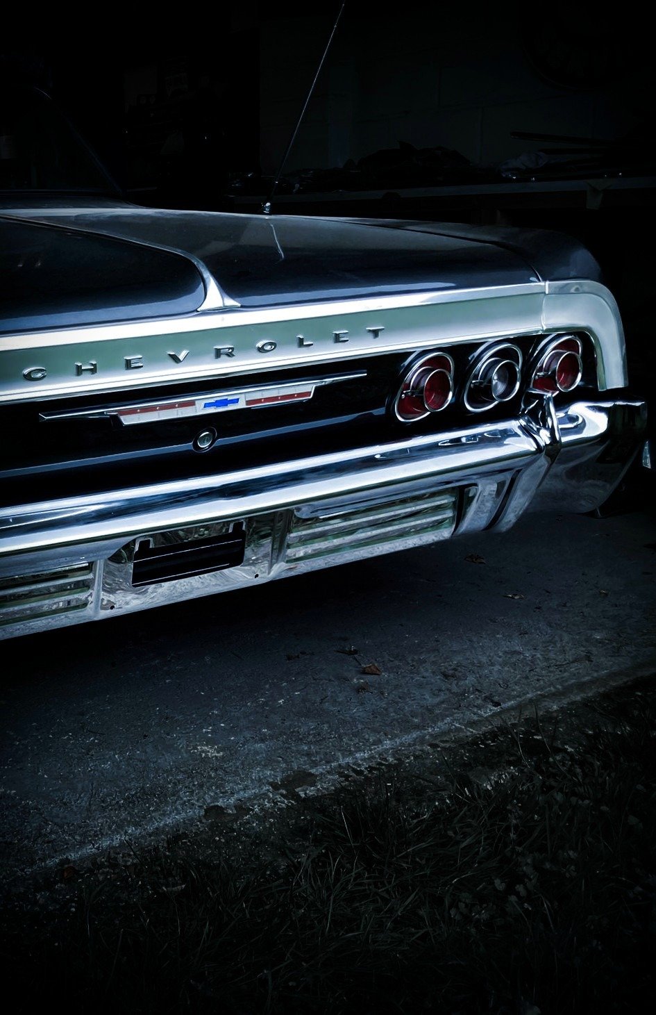Polished chrome and signature triple rear lights of the 1964 Chevrolet Impala